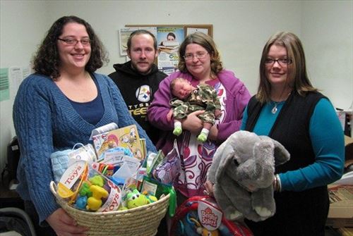Pictured L-R:  Sheri N. Price, Community Action, Inc.'s Early Care and Education Coordinator; Michael Reed; Elizabeth Reed holding baby Derek Michael; and Samantha L. Schrecengost, Community Action, Inc.'s Community Service Assistant.