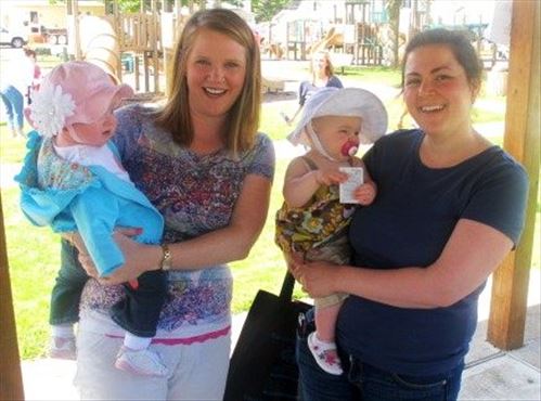 Mothers Carley Armagost (left with daughter Adalynn) and Jessica Monger (right with daughter Charlotte)and other families of young children learned the value of nutrition, exercise and reading at the Story Walk with Eric Carle's The Very Hungry Caterpillar.