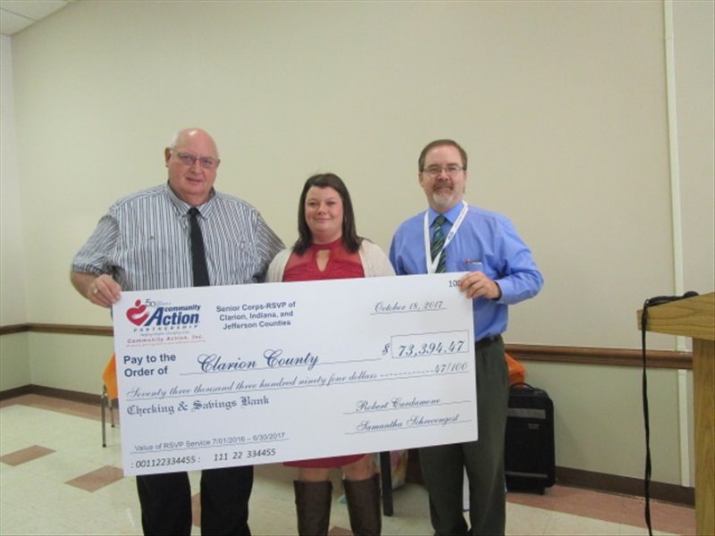 Community Action, Inc.'s Senior Corps-RSVP Director, Samantha Schrecengost, presented a ceremonial check for $73,394.47 to County Commissioners Ed Heasley and Wayne Brosius the value of the 10,123.25 hours served by the Senior Corps-RSVP volunteers in Clarion County July 1, 2017 through June 30, 2017.