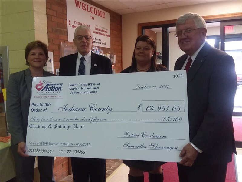 Community Action, Inc.'s Executive Director, Robert Cardamone, and Senior Corps-RSVP Director, Samantha Schrecengost, presented a ceremonial check for $64,951.05 to Indiana Commissioners Sherene Hess and Rodney Ruddock acknowledging the current value of the 8,958.6 hours served by the Senior Corps-RSVP volunteers in Indiana County.