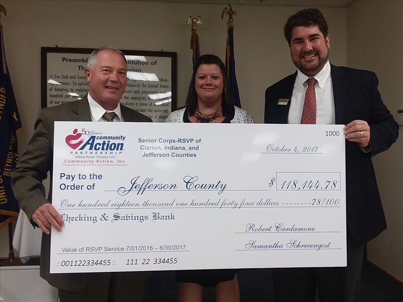 Community Action, Inc.'s Senior Corps-RSVP Director, Samantha Schrecengost, presented a ceremonial check for $118,144.78 to County Commissioners Jeff Pisarchick and Jack Matson the value of the 16,295.8 hours Senior Corps-RSVP Volunteer served in Jefferson County July 1, 2016 through June 30, 2017.